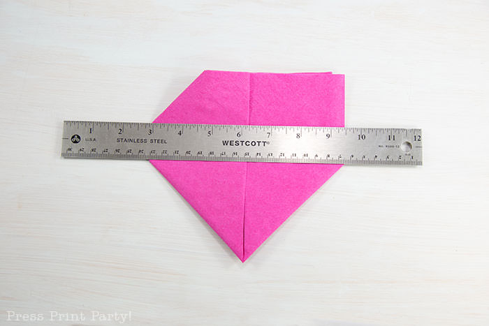 Heart Fold Napkin instructions- How to fold a napkin like a heart - paper napkin or cloth napkins - By Press print Party. Pink paper napkin folded like a heart DIY tutorial