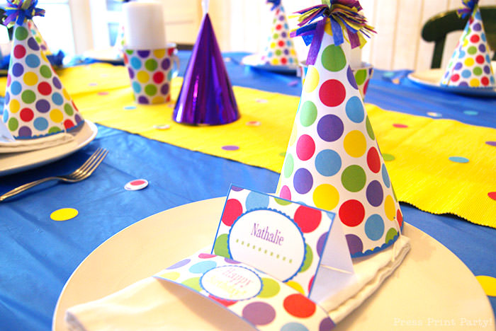 5 ways to make your kid's birthday special at home. Celebrate at home with family Press Print Party. Birthday party decorations on table with party hat colorful dots