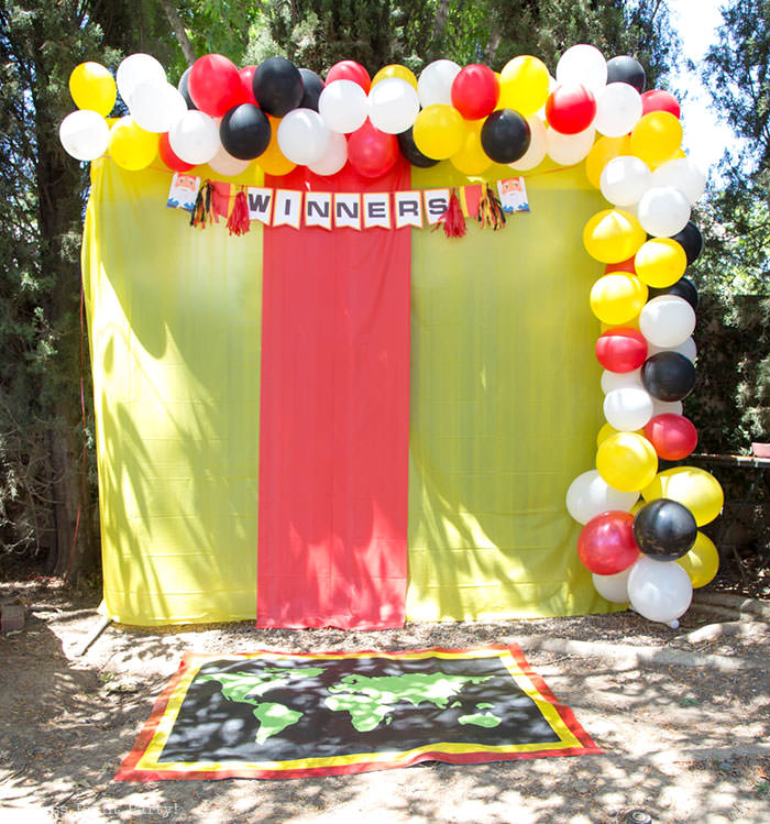 Backdrop with balloons and winner pit stop mat The amazing race party ideas - Press Print Party!