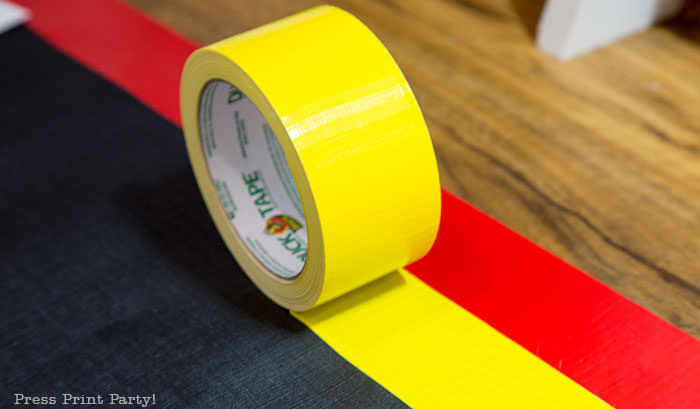 Red and yellow duct tape to use on the edges of the homemade amazing race pit stop mat.