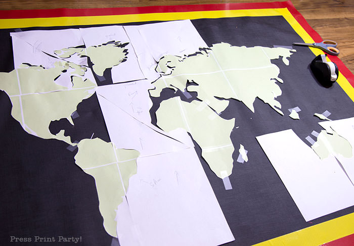 Homemade amazing race pit stop mat with map printout before painting.