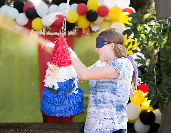 Girl hitting pinata. The amazing race party ideas - Roaming gnome pinata DIY - Press Print Party!