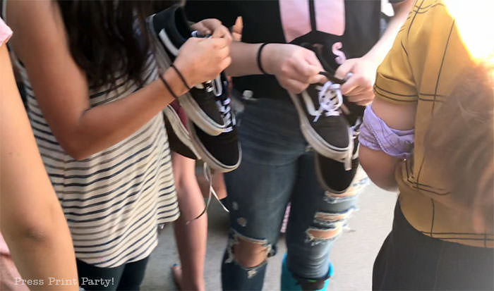 Girls looking for their shoes for our amazing race birthday party - Press Print Party!