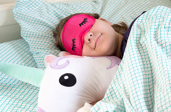 sleeping girl with sleep mask with eyelashes and unicorn pillow. Press Print Party!