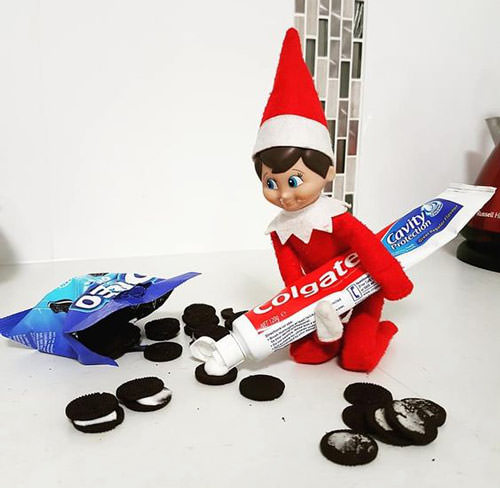 elf on the shelf putting toothpaste in oreos