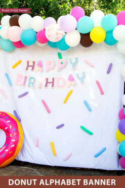 Happy birthday donut birthday alphabet banner garland. photo booth with balloons and inflated donut balloon. Press Print Party!