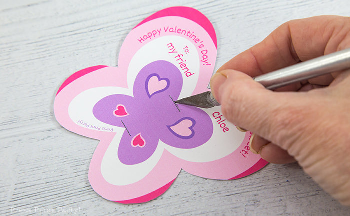 Cutting the slit on the butterfly lollipop card with an xacto knife