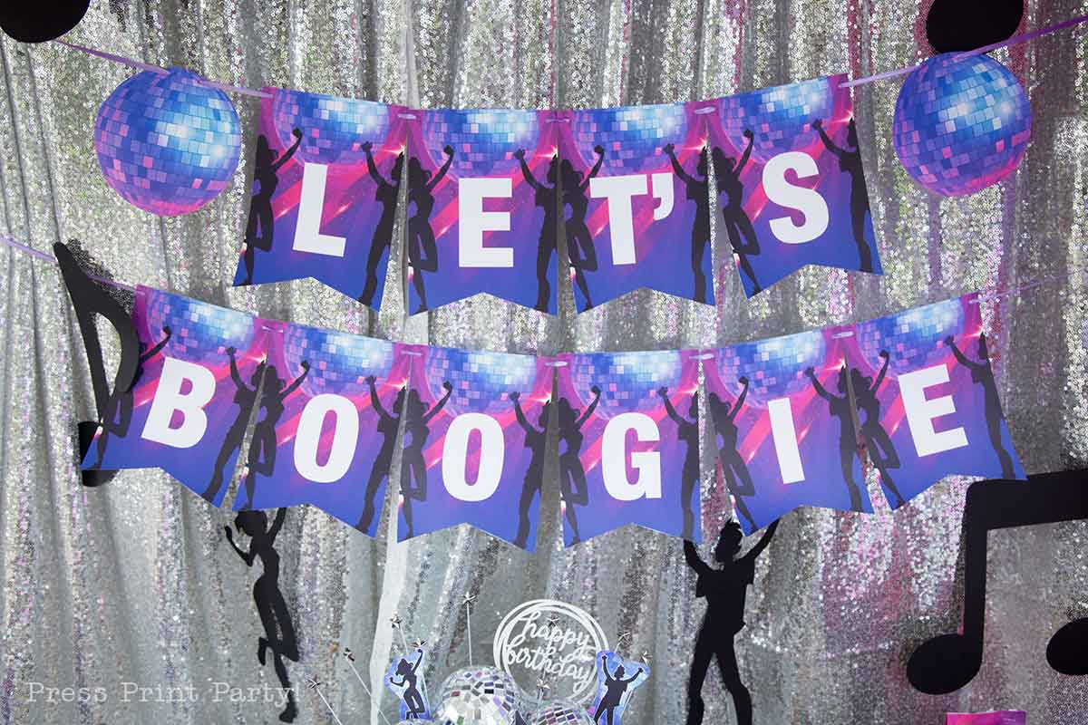 Two rows of banners spelling “LET’S BOOGIE” with silhouettes of dancers and disco balls, hanging against a sparkling silver backdrop—perfect for dance or disco-themed celebrations and fun teen birthday party ideas.