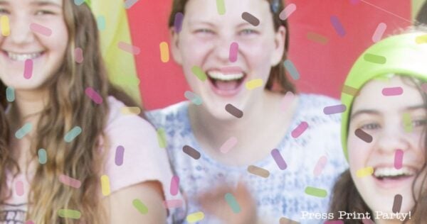 Three smiling girls are partially visible, standing together with colorful confetti-like sprinkles overlaying the image—a perfect snapshot for anyone searching for teen birthday party ideas. The background has red and yellow tones, while the words “Press Print Party!” appear in the lower right corner.