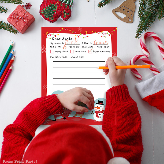 boy writing a letter to santa on a free printable template. Press Print Party