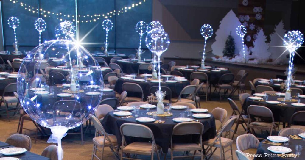 Christmas banquet with tables and bobo balloon led lights. Press Print Party!