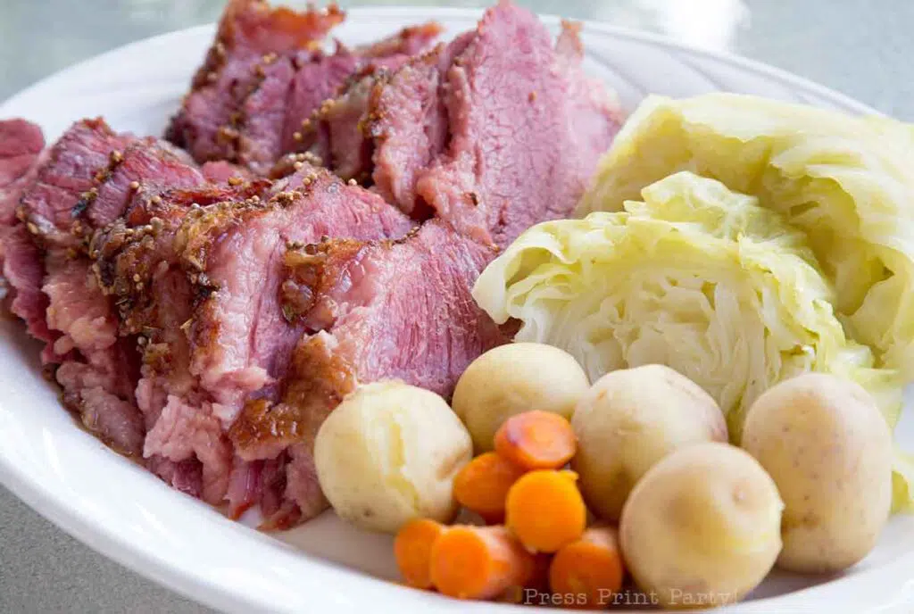 oven roasted corned beef and steamed cabbage on a plate with potatoes and carrots. Press Print Party!