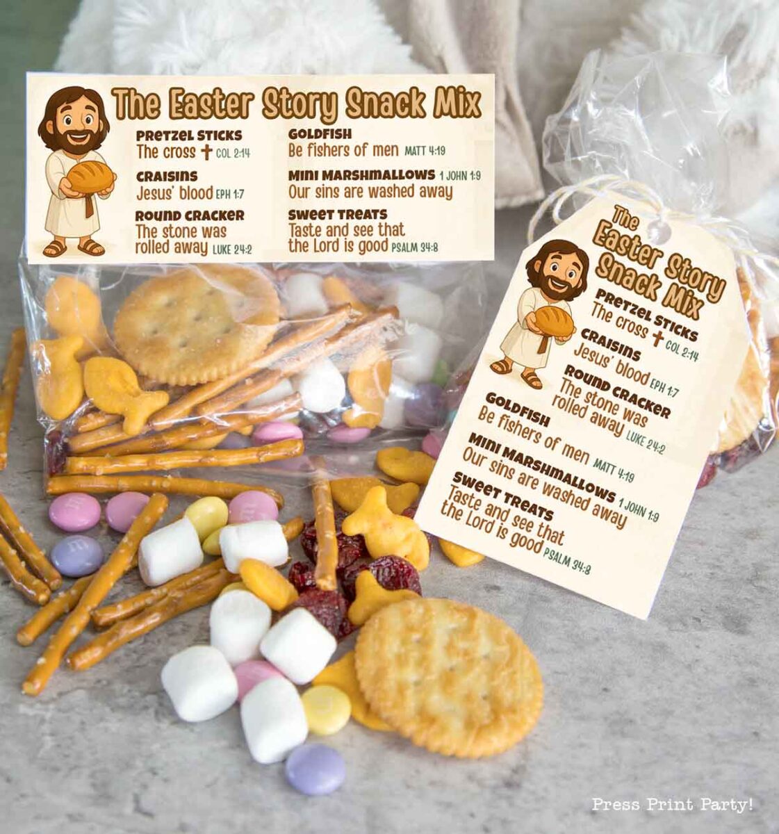Bags of Easter Story Snack Mix come with a label, featuring pretzel sticks, goldfish crackers, mini marshmallows, round crackers, and craisins—each symbolizing parts of the Easter tale.