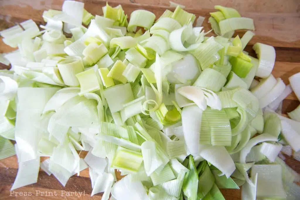 flamiche aux poireaux french leek tart. cut leek on wooden board. Press Print Party!