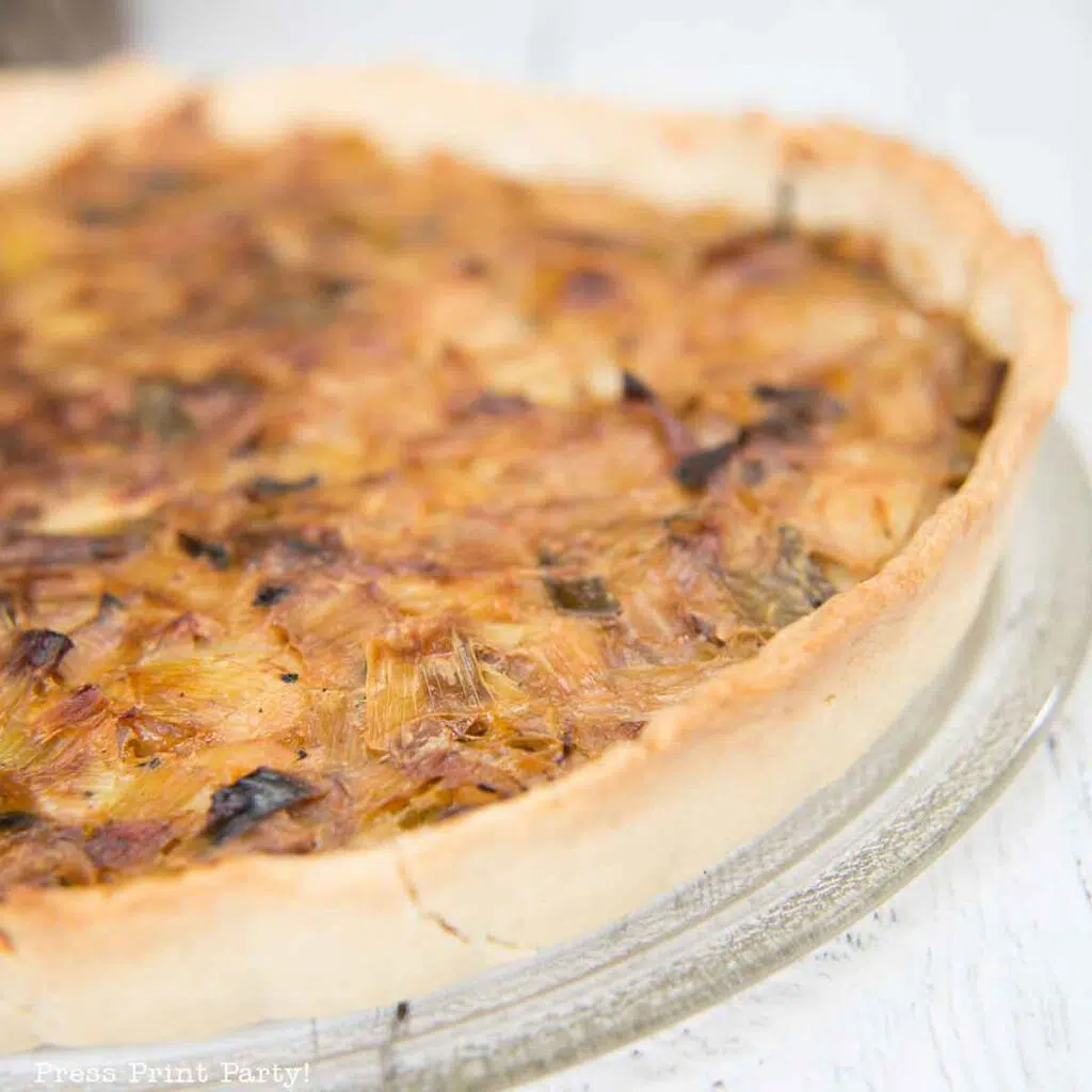 Leek tart. flamiche aux poireaux french leek tart. cooked on white board. Press Print Party!