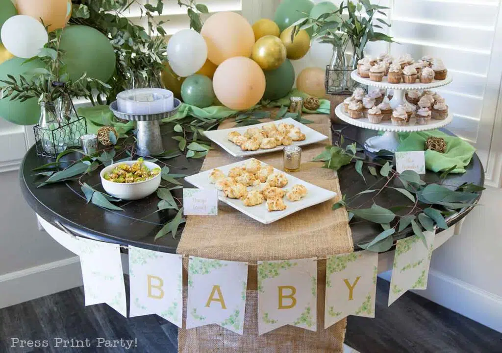 Greenery baby shower decor ideas with printable banner and eucalyptus on table - Press Print Party!