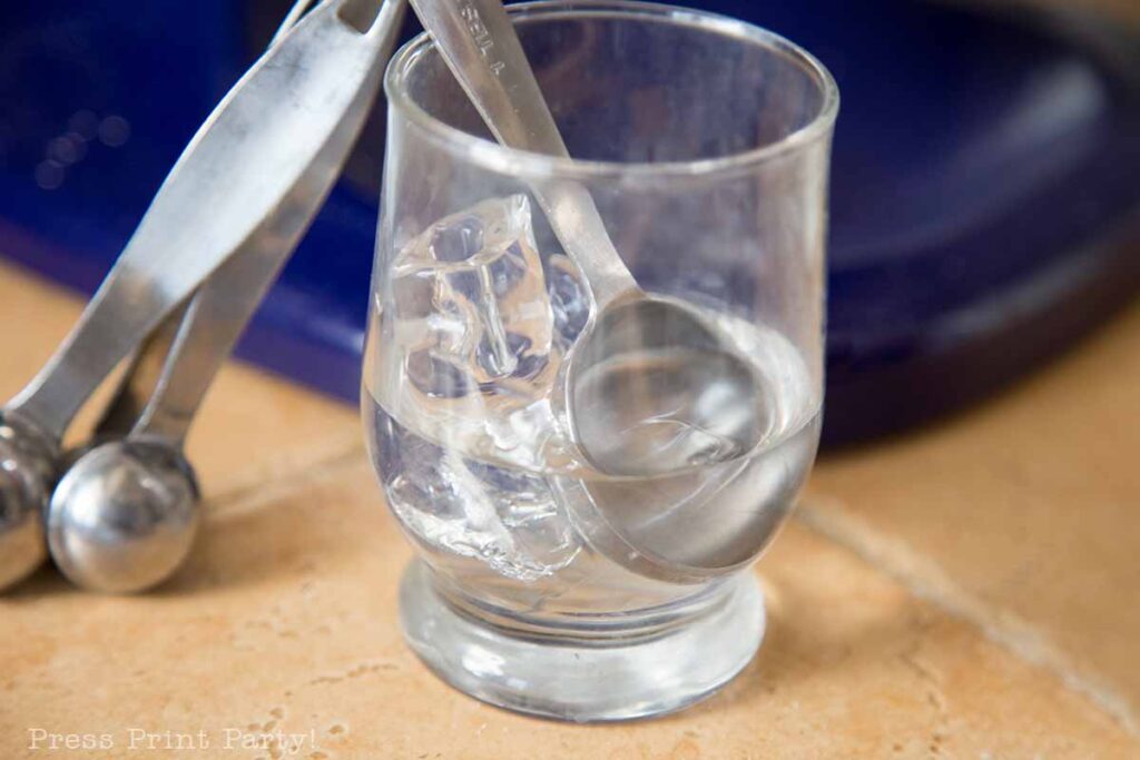 glass of ice water with measurin spoons - easy pie crust homemade recipe with butter - Press Print Party!