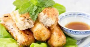 fried vietnamese egg rolls on plate with dip mint and lettuce- How to make vietnamese egg rolls recipe cha gio nem ran - Press Print Party!