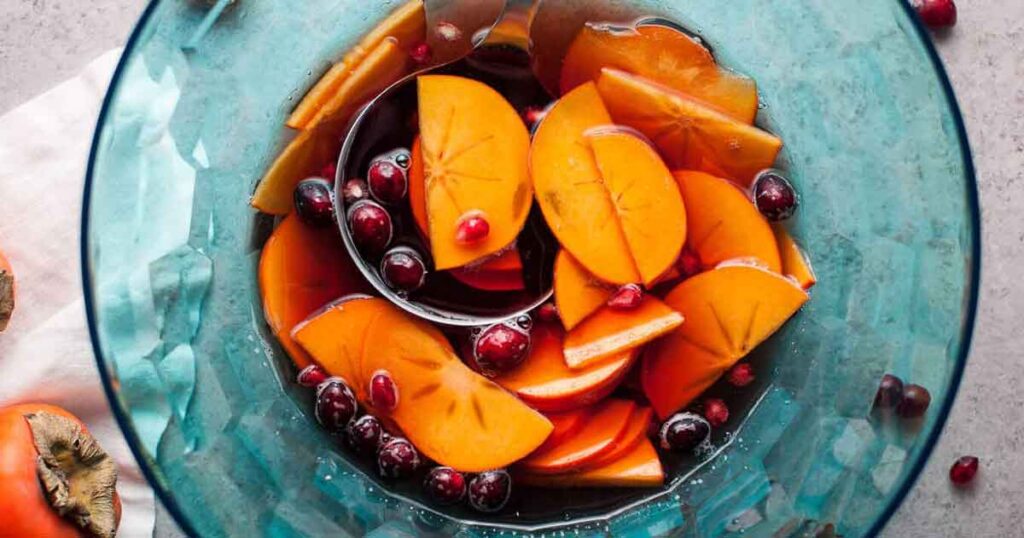 pomegranate persimmon ssangria recipe - 35 Great Christmas Punch Recipes to Make for a Crowd Press Print Party