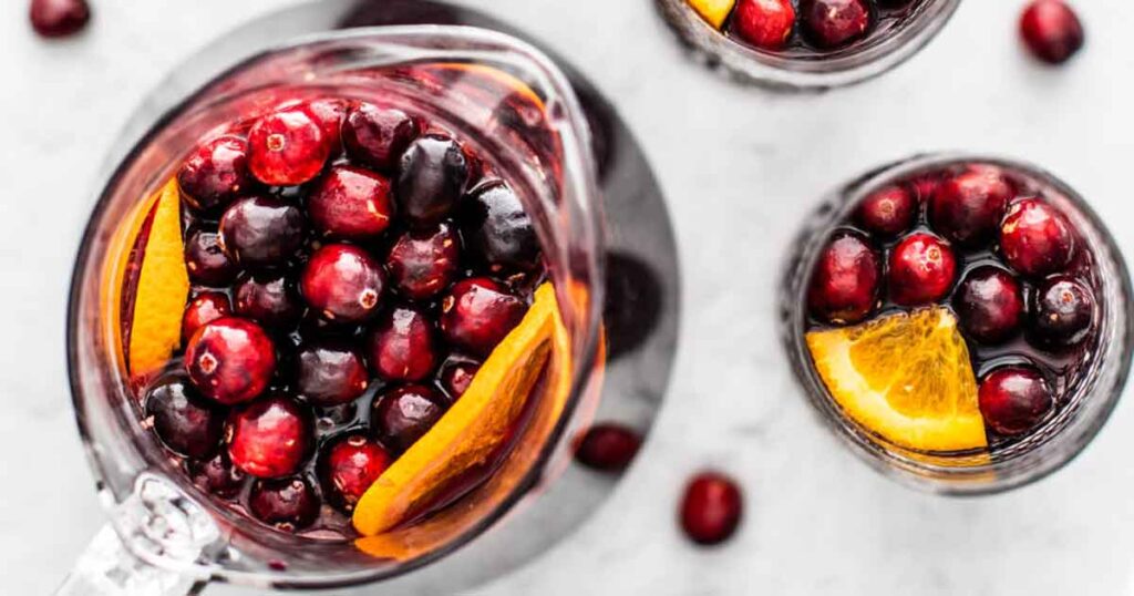 cranberry orange sangria recipe - 35 Great Christmas Punch Recipes to Make for a Crowd - holiday party punch - Press Print Party