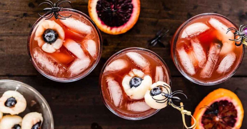 orange halloween punch with eyes- 33 Wickedly Fun Recipes for Halloween Drinks ideas non alcoholic for Kids & alcoholic for Adults - Press Print Party