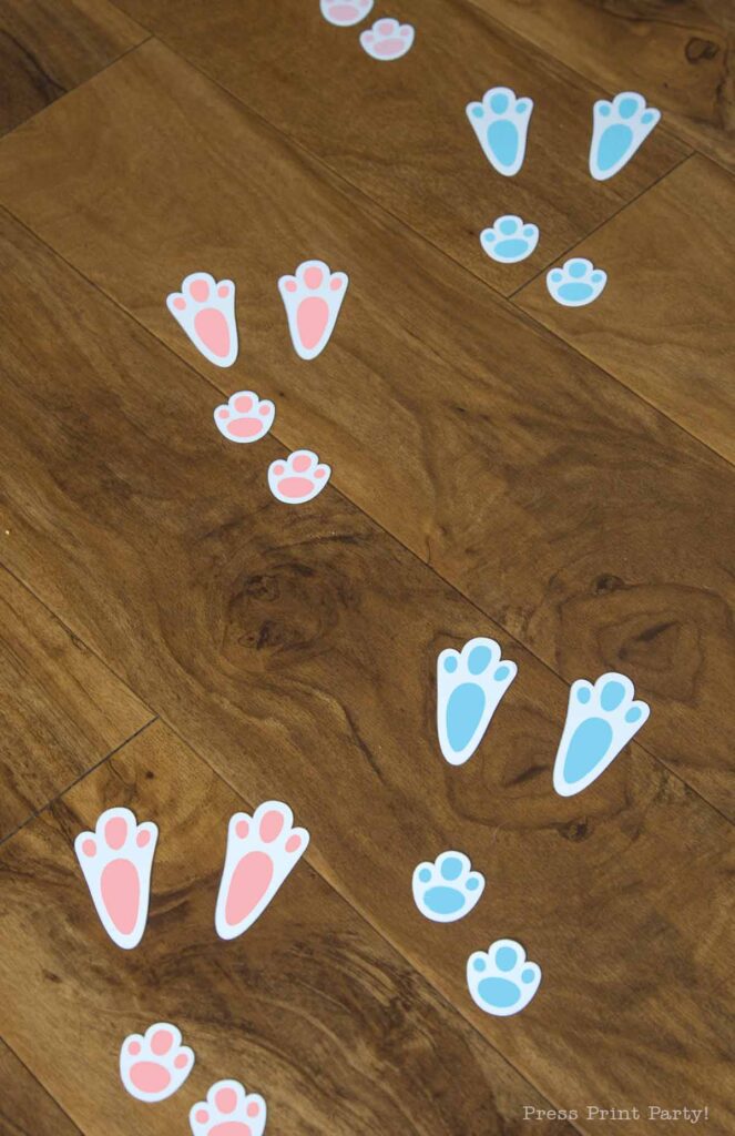 free printable easter bunny footprints and stencils in 2 sizes and 2 colors blue and pink.  on brown floor - Press Print Party!