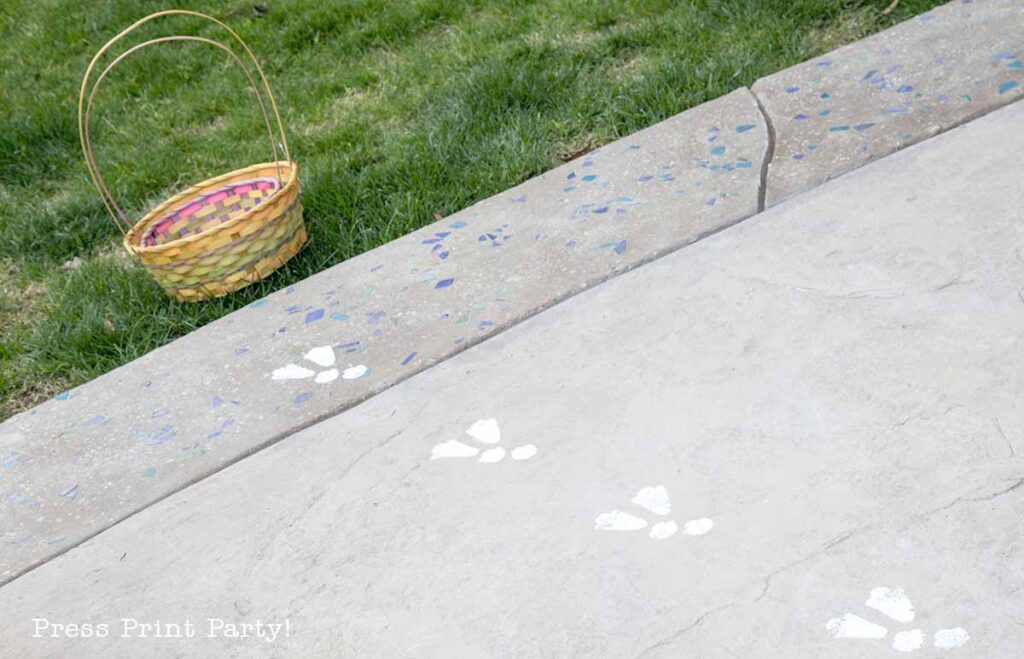 free printable easter bunny footprints and stencils in 2 sizes and 2 colors blue and pink. with Easter baskets on concrete floor in garden- Press Print Party!