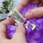 fold dollar bill around the separator to make a money lei - Press print Party