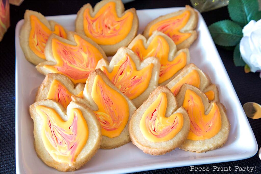 flame cookies with sugar cookies and orange and red icing- Our epic hunger games party for teens, hunger games party theme birthday party, food, decorations and games - Press Print Party