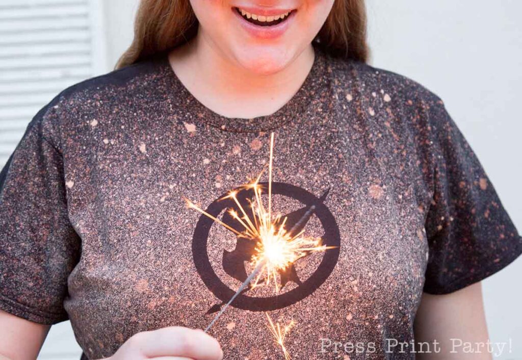 Lighting the sparkler in victory - 5 creative hunger games party activities and games with scavenger hunt and free printables. press print party!