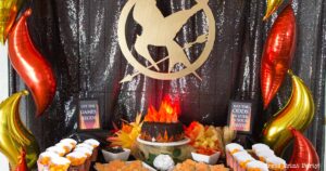 desert table with mockingjay sign, coal on fire cake, printables, and treats- Our epic hunger games party for teens, hunger games party theme birthday party, food, decorations and games - Press Print Party
