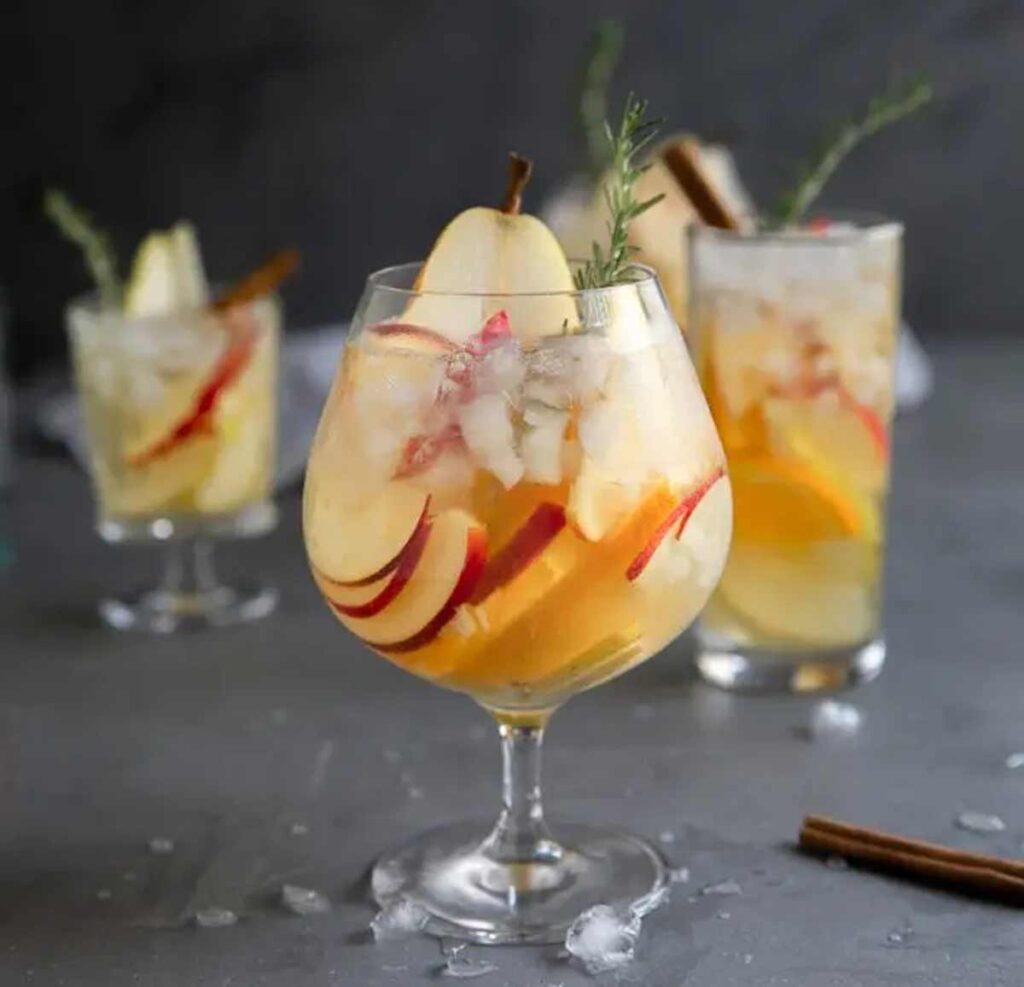 apple pear sangria glass- Tasty Thanksgiving punch recipe non-alcoholic and alcoholic to feed a crowd. Press Print Party