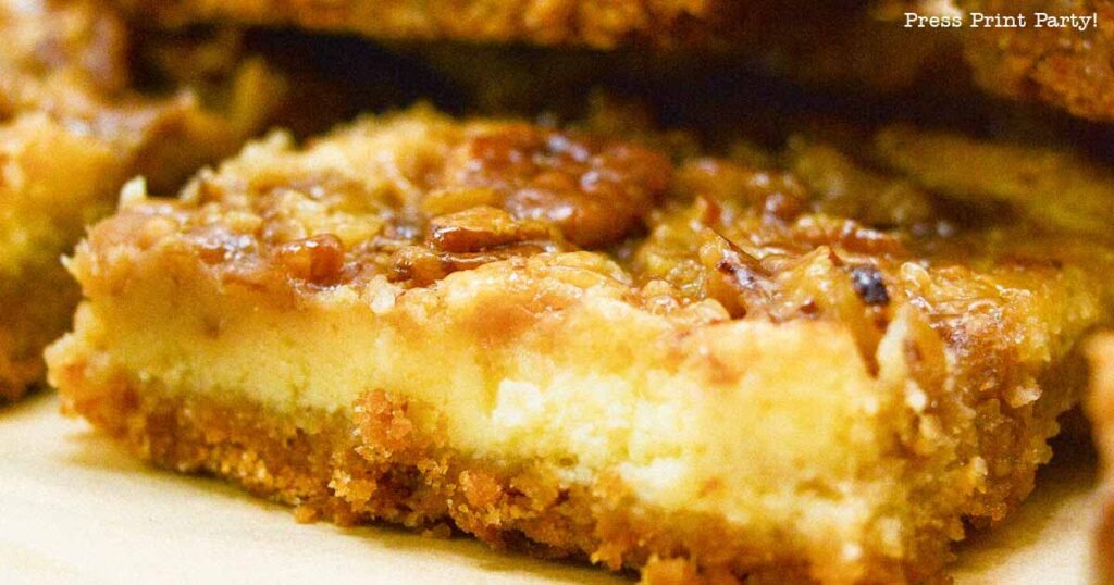 easy pecan pie cheesecake bars recipe squares. graham cracker crust,  cheesecake. caramel and pecans on top. great for thanksgiving fall recipe treat. Press Print Party!