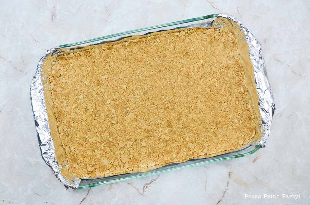 graham cracker crust layer - easy pecan pie cheesecake bars recipe squares. graham cracker crust, cheesecake. caramel and pecans on top. great for thanksgiving fall recipe treat. Press Print Party!