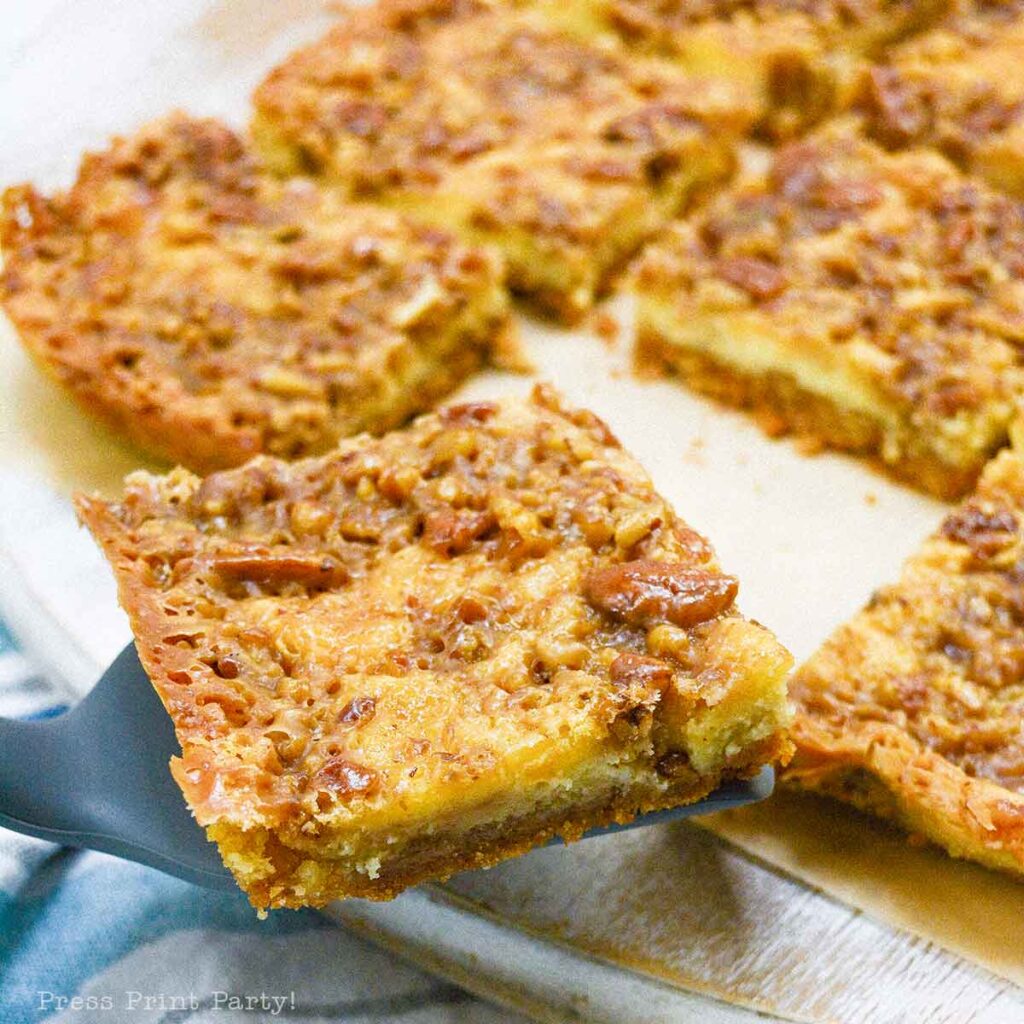 easy pecan pie cheesecake bars recipe squares. graham cracker crust, cheesecake. caramel and pecans on top. great for thanksgiving fall recipe treat. Press Print Party!