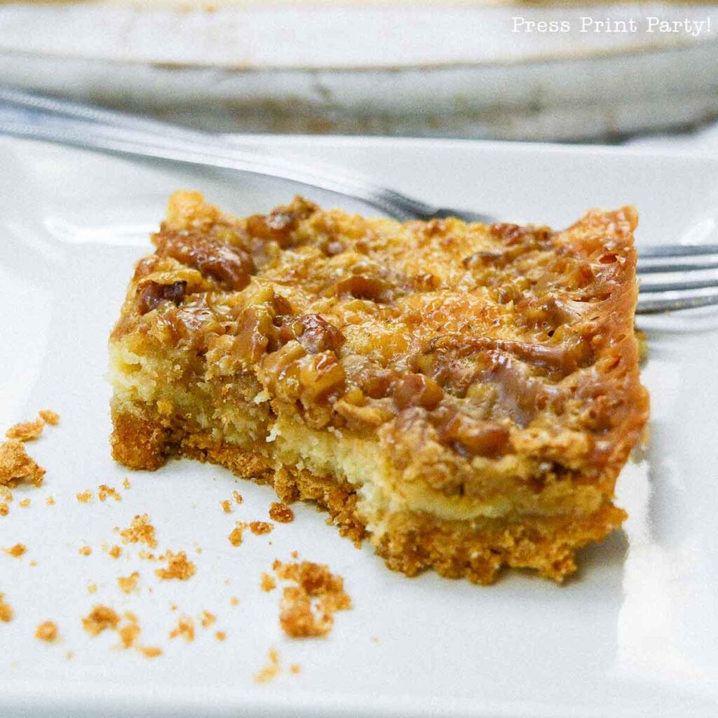 easy pecan pie cheesecake bars recipe squares. graham cracker crust, cheesecake. caramel and pecans on top. great for thanksgiving fall recipe treat. Press Print Party!