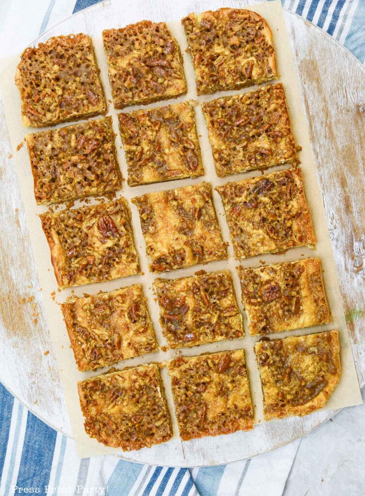 easy pecan pie cheesecake bars recipe squares. graham cracker crust, cheesecake. caramel and pecans on top. great for thanksgiving fall recipe treat. Press Print Party!