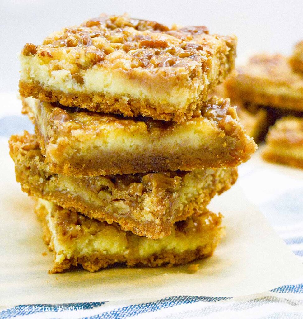 easy pecan pie cheesecake bars recipe squares. graham cracker crust, cheesecake. caramel and pecans on top. great for thanksgiving fall recipe treat. Press Print Party!