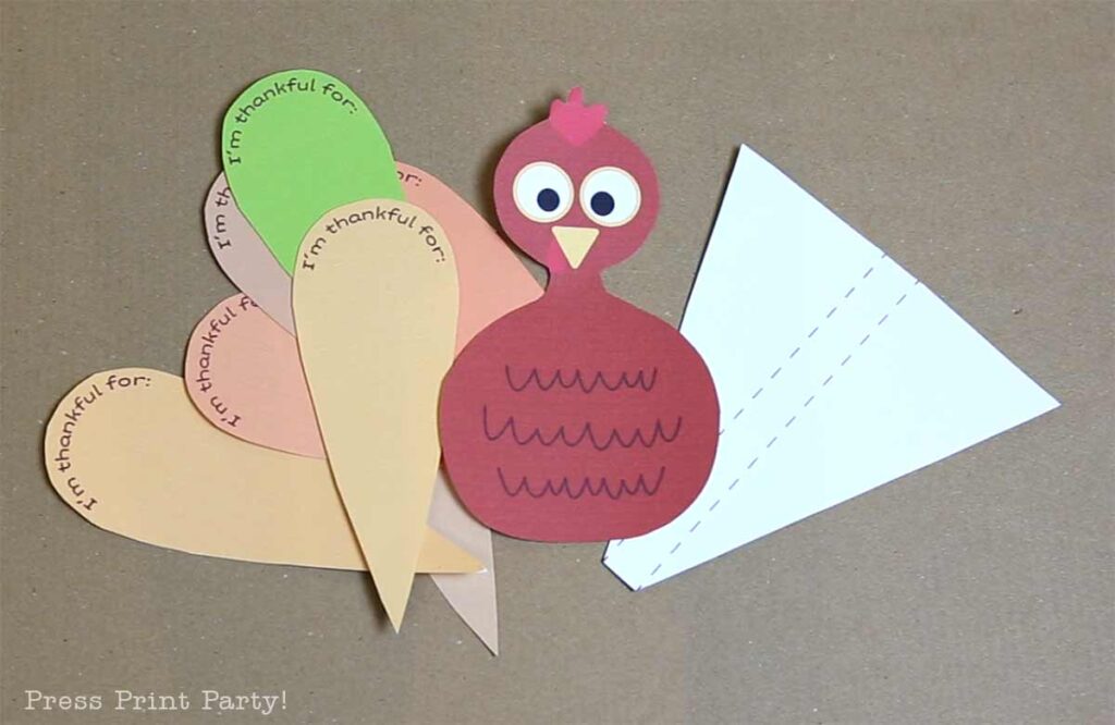 Cut up thankful turkey craft on table - Free thankful turkey printable craft template for kids - Press Print Party!