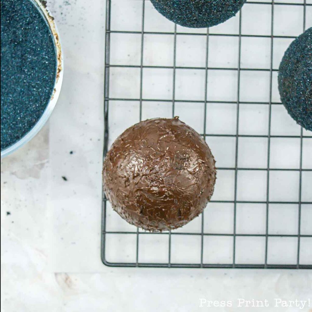 covering your hot cocoa bombs in chocolate - Lump of coal Christmas Hot chocolate bombs - Press Print Party!