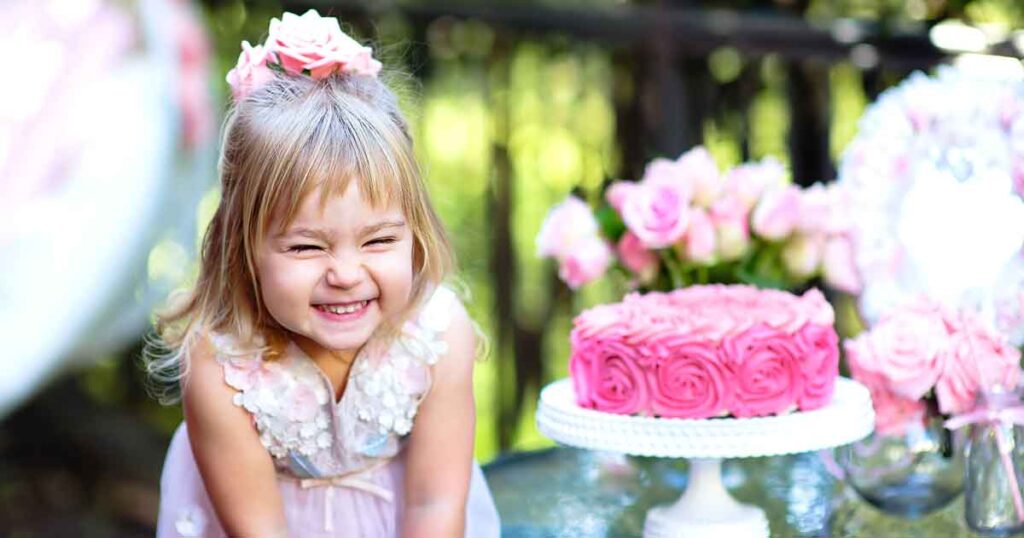 Girl laughing at her birthday party. 15 fun birthday party activities for toddlers and young kids - Press Print Party!