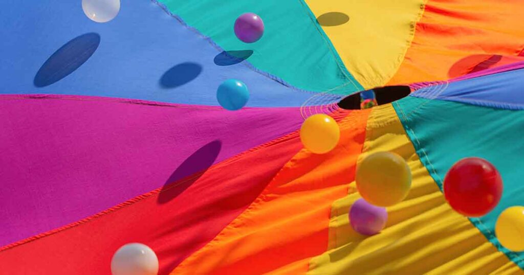 play parachute - 15 fun birthday party activities for toddlers and young kids - Press Print Party!