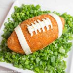 football cheese ball on bed of onions - football shaped cheese ball - cheese footballs - Press Print Party!