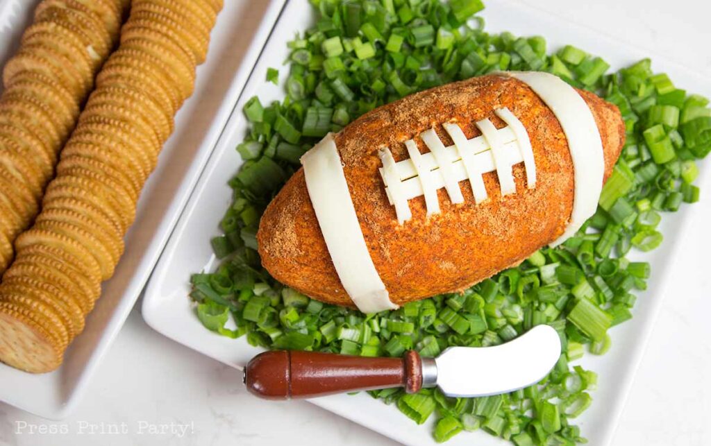 football cheese ball on bed of onions - football shaped cheese ball - cheese footballs - Press Print Party!