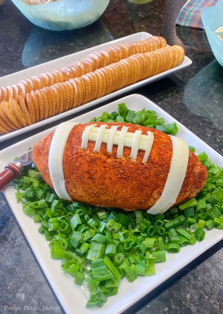 football cheese ball on bed of onions - football shaped cheese ball - cheese footballs - Press Print Party!