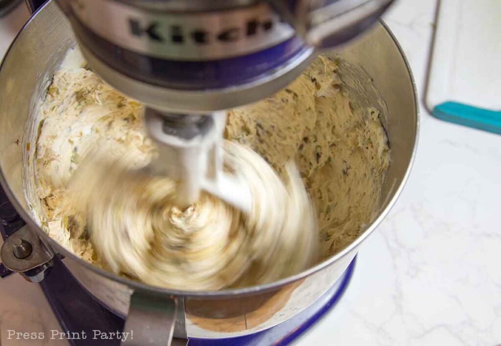 mixing football cheese ball- football shaped cheese ball - cheese footballs - Press Print Party!