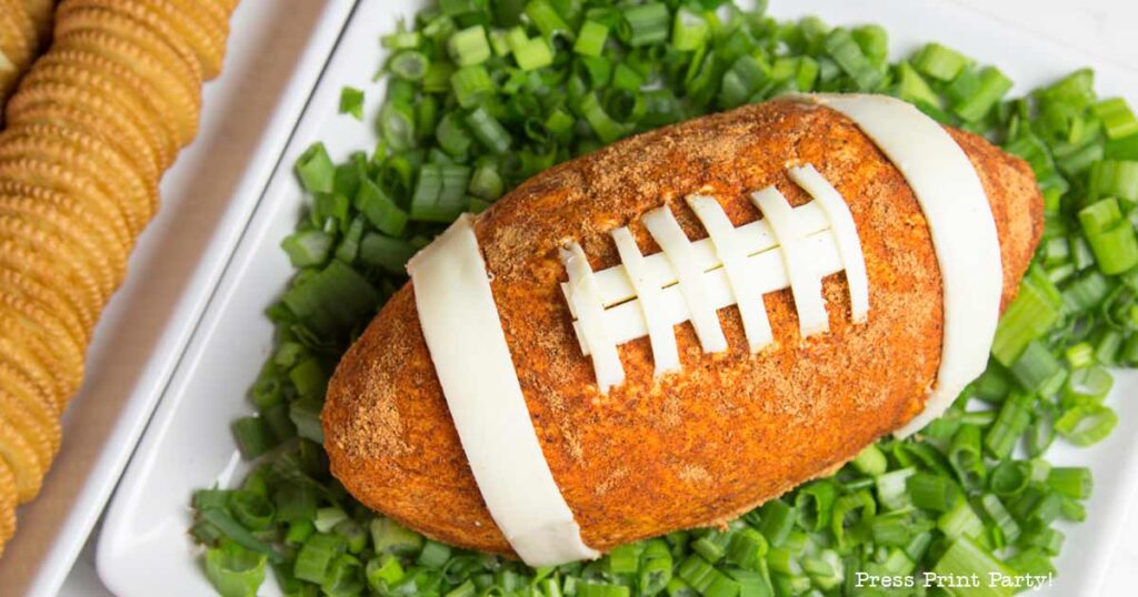 football cheese ball on bed of onions - football shaped cheese ball - cheese footballs - Press Print Party!