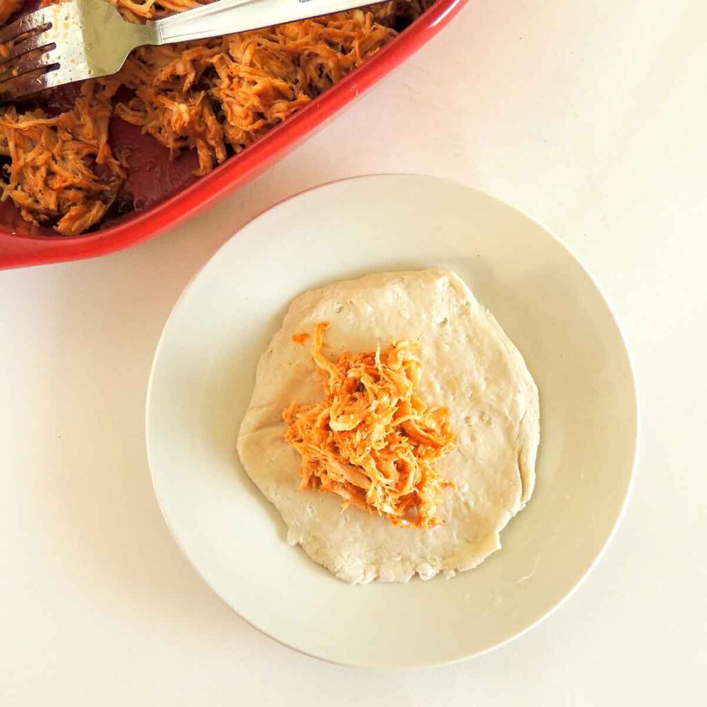 flattened biscuit with buffalo chicken- Tasty pulled buffalo chicken football hand pies - Press Print Party!