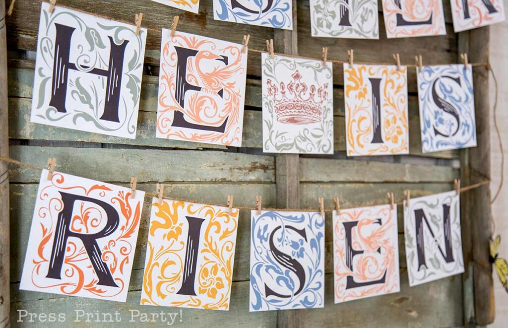 He is Risen free printable banner on wood with colorful florals - Press Print Party