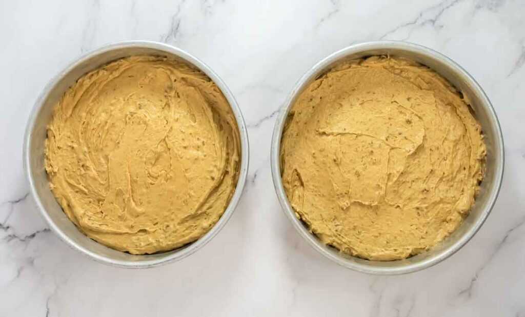 2 cake pans side to side with cake batter before baking